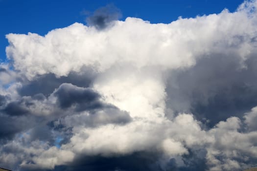Cumulonimbus cloud formations on blue sky, gray and white clouds hunk