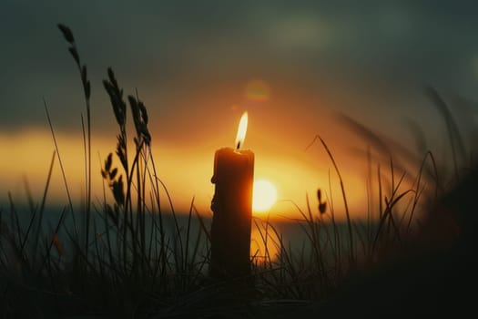Silhouette of a lone candle burning in remembrance.