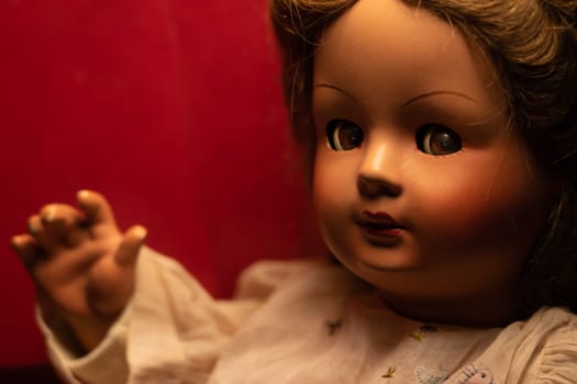 Scary vintage doll in half light. Close up