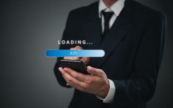 Businessman holding a smartphone with a digital loading progress bar. Ideal for mobile app development, technology presentations, and software updates.