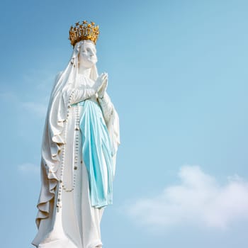 Lourdes, France - August 28, 2021: Sculpture of the crowned Virgin Mary in the Sanctuary of Lourdes in France, square photography
