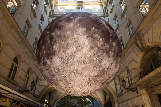 Budapest, Hungary - September 29 2024: Detailed replica of the moon's entire surface. A striking installation, floating 3.5 meters high in Piarista köz, near Elizabeth Bridge in Budapest