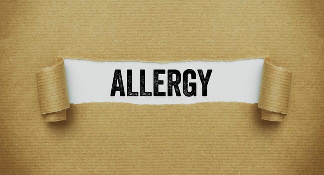Torn paper revealing the word Allergy
