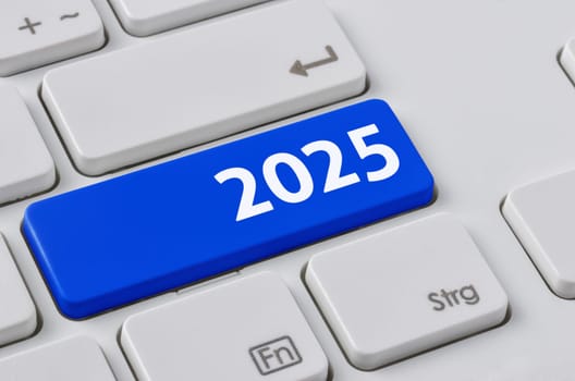 A keyboard with a blue button - 2025