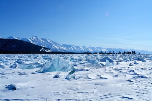 The shore of Lake Baikal in winter. Snow and ice on the baikal.