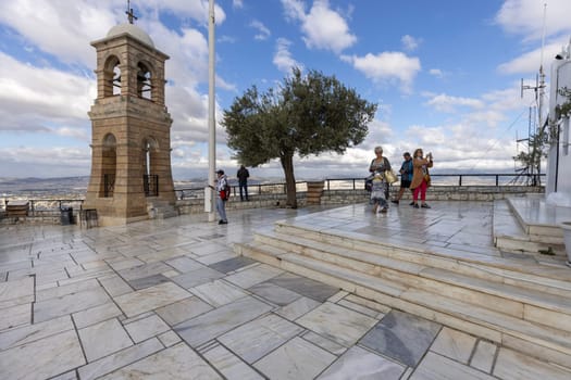 Athens, Greece - October 18, 2022: Observation deck on top of Mount Lycabettus with bell tower of Saint George's chapel, aerial view of the city.Peak is the highest point in Central Athens