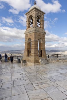 Athens, Greece - October 18, 2022: Observation deck on top of Mount Lycabettus with bell tower of Saint George's chapel, aerial view of the city.Peak is the highest point in Central Athens