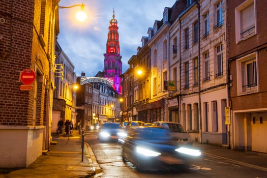 Arras, France - december 30 2023 : View over the illuminated Belfry and cars inmotion from the street, photography taken during the Christmas holidays