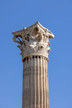 Athens, Greece - October 19, 2022: Decorative corinthian column in remains of Temple of Olympian Zeus on a background of blue sky.