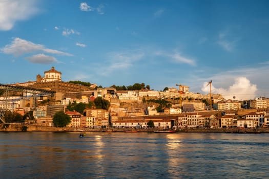 View of Vila Nova de Gaia city riverfront with Mosteiro da Serra do Pilar monastery and Dom Luis I bridge over Douro river on sunset. Porto, Vila Nova de Gaia, Portugal