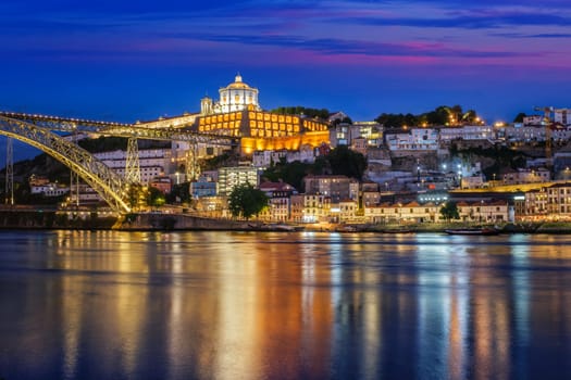 View of Vila Nova de Gaia city with Mosteiro da Serra do Pilar monastery and Dom Luis I bridge over Douro river in evening twilight. Porto, Vila Nova de Gaia, Portugal