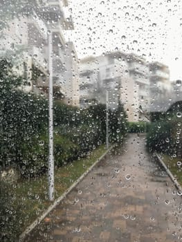 Rain drops on a window. Looking out of the window on a wet and rainy day.
