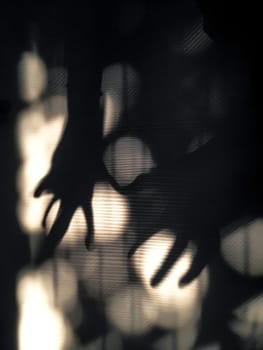 Abstract image of shadow hands grasping light