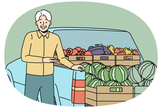 Elderly man farmer stands near car with fresh fruits and vegetables, selling healthy food at farms fair. Gray-haired farmer with smile showing organic watermelons grown without use of pesticides
