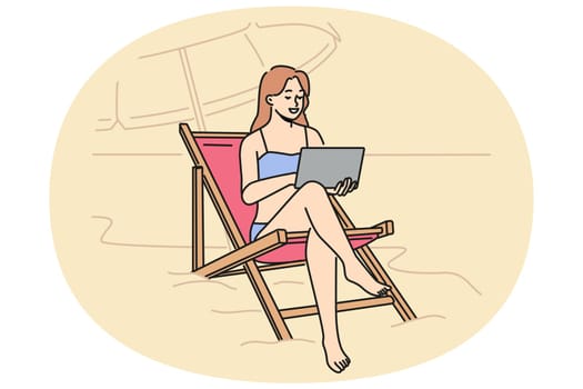 Woman freelancer working on beach, sitting in sun lounger with laptop on lap and enjoying comfort. Girl freelancer resting on sea during summer vacation and holding electronic tablet