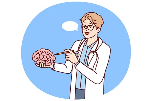 Doctor holds brain in hand explaining work of neurons to students of medical college or university. Concept studying human brain to find possibility of treating alzheimer disease or dementia