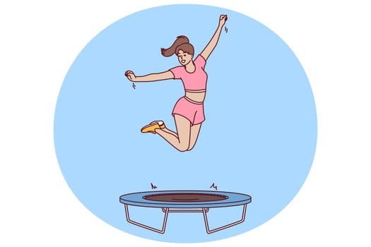 Woman fitness trainer jumps on trampoline teaching clients of sports club to do exercises correctly. Girl is engaged in fitness using trampoline for jumping helping to become slim and beautiful