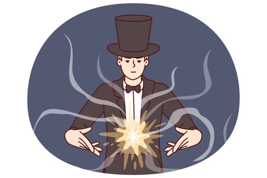 Man magician demonstrates magic tricks to entertain guests of circus or entertainment event. Mysterious guy magician in black tuxedo hat takes part in television show of illusionists