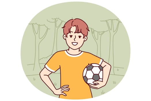 Little boy with soccer ball enjoys outdoor recreation and with smile looks at screen. Boy pupil elementary school, dreams of becoming professional football player and training in park to play soccer