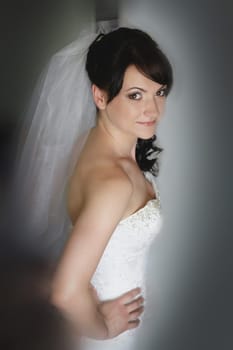 The radiant bride is adorned in a stunning white gown, showcasing her enchanting elegance and timeless beauty