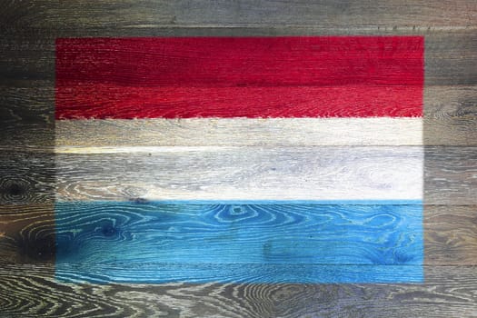 A Luxembourg flag on rustic old wood surface background