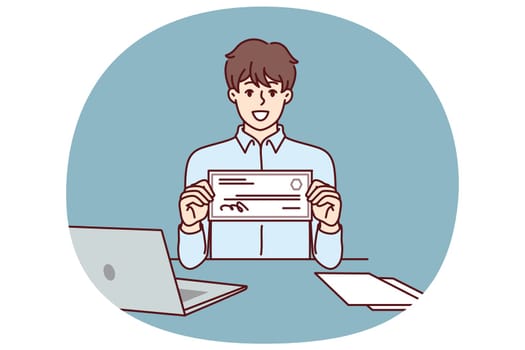Businessman with paycheck sits at office desk with laptop showing off investments in start-ups from large corporations. Man with paycheck at his workplace demonstrates certificate for large amount