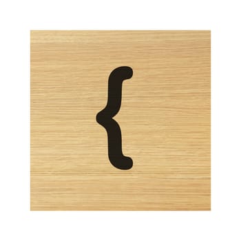 An open curly bracket brace sign on childs wood block on white with clipping path