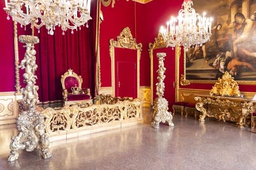 Genoa, Italy - 06 August 2023: Royal Palace, throne room interior, gold and red velvet