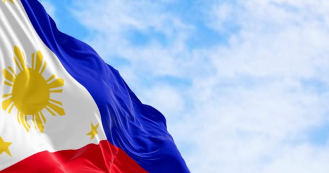 Close-up of Philippines national flag waving. Two equal horizontal blue and red bands, white triangle on the left, golden-yellow sun with eight beams at its center. 3d illustration render