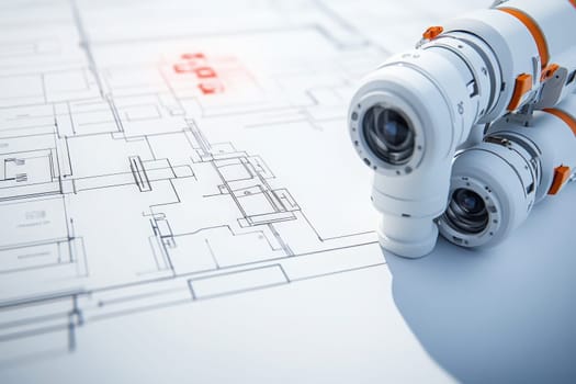 A handheld diagnostic tool rests on architectural plans, emphasizing its role in evaluating design accuracy and measurements in engineering. Its features assist professionals in precise assessments.