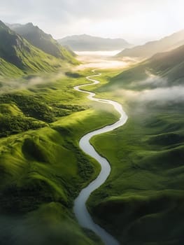 A serene river winds through lush green valleys, under a misty sky, creating a picturesque and tranquil landscape.