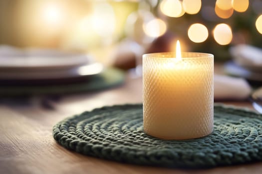 A glowing candle sits on a green placemat, illuminating a serene dining table adorned with festive decor.