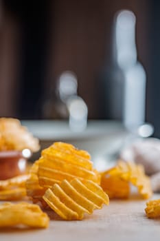 Crispy potato chips on a kitchen table.