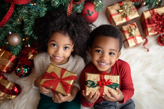 Two children smile while holding wrapped gifts under a beautifully decorated Christmas tree, creating a festive atmosphere of joy and excitement.