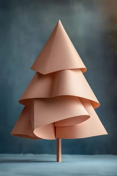 A creative paper tree stands elegantly on a blue backdrop, showcasing unique layered design and soft hues perfect for festive decor.