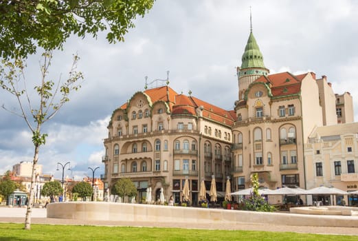 Oradea, Romania - October 07, 2024: Vulturul negru secession Palace, or Black Eagle Palace,  with terraces, Art Nouveau building at Unity Square (Piata Unirii)