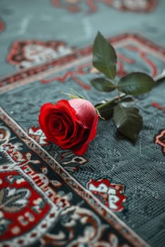 Simple background with a single rose placed on a prayer mat, symbolizing devotion and love.