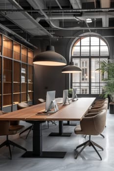 A modern office space with a large wooden table and several chairs. The room is well lit and has a professional atmosphere