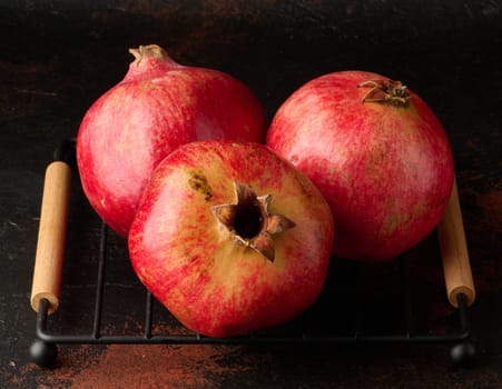 Ripe red pomegranate on brown background