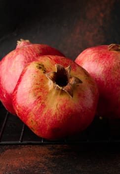 Ripe red pomegranate on brown background