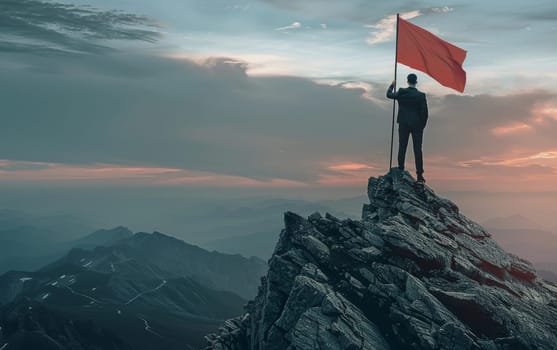 As the sun sets, a businessman celebrates a metaphorical victory on a summit, his red flag catching the last light of day