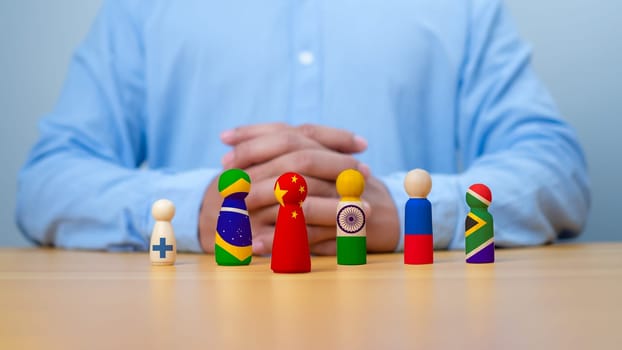 Brazil Russia India China South Africa and white flag print screen on wooden figure for BRICS plus economic international cooperation concept, New group of powerful rising states.