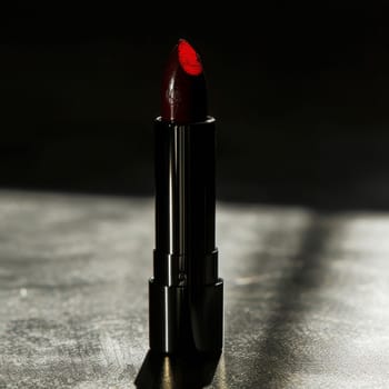 Striking silhouette of a lipstick bullet casting dramatic shadows.