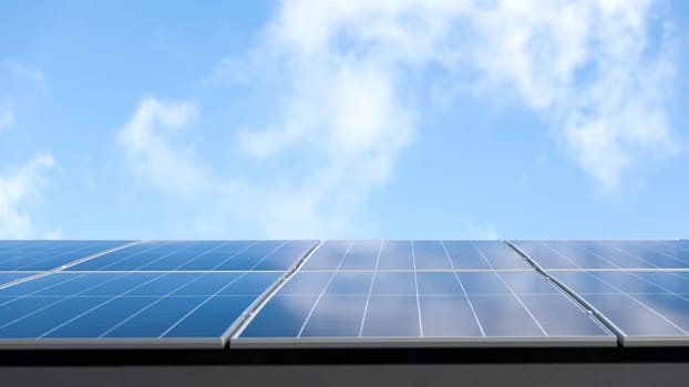 Aerial view of solar panel cells against cloudy blue sky. Alternative energy concept, sustainable resources. House with solar panels stand-alone photovoltaic plant system. Professional installation
