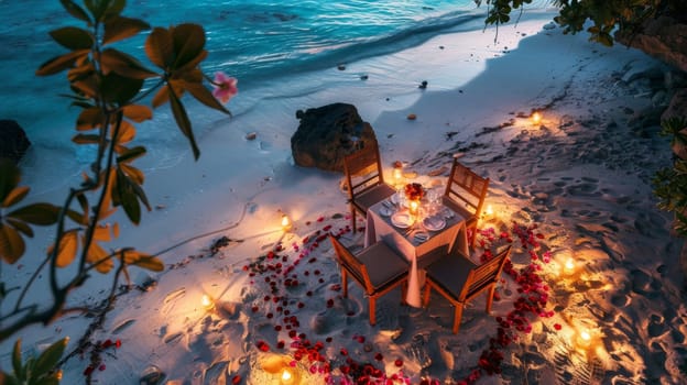 A romantic dinner setup with candles and rose petals on a secluded beach, captured from a high angle