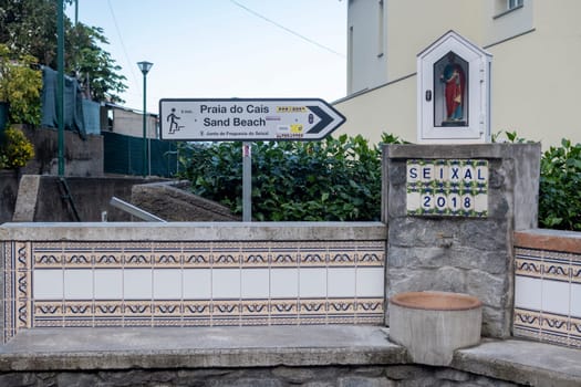 Seixal, Madeira, Portugal, November 3rd 2024: Direction sign to Praia do Cais Sand Beach in Seixal on Madeira Island, Portugal