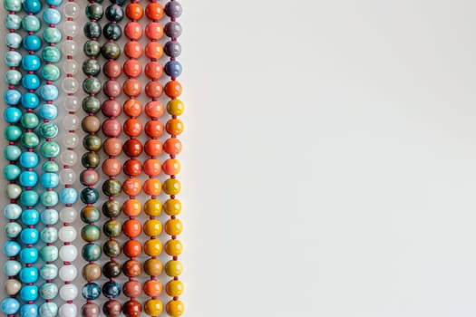 Minimalist composition of Islamic prayer beads arranged neatly against a white surface.