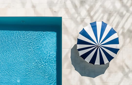 A serene pool reflects sunlight beside a striped umbrella, perfect for a day of relaxation in a tranquil outdoor setting.