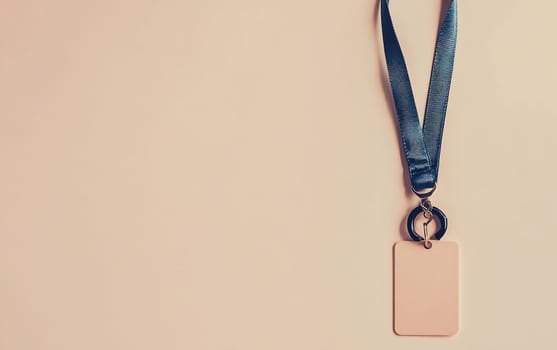 A medal hangs from a blue ribbon, featuring a blank tag attached, suitable for customization. It has a minimalist design and soft colors.