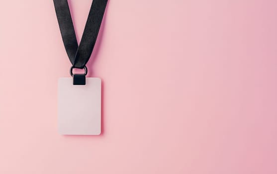 A blank identification badge hangs from a black lanyard against a soft pink background, ready for personalization or use.